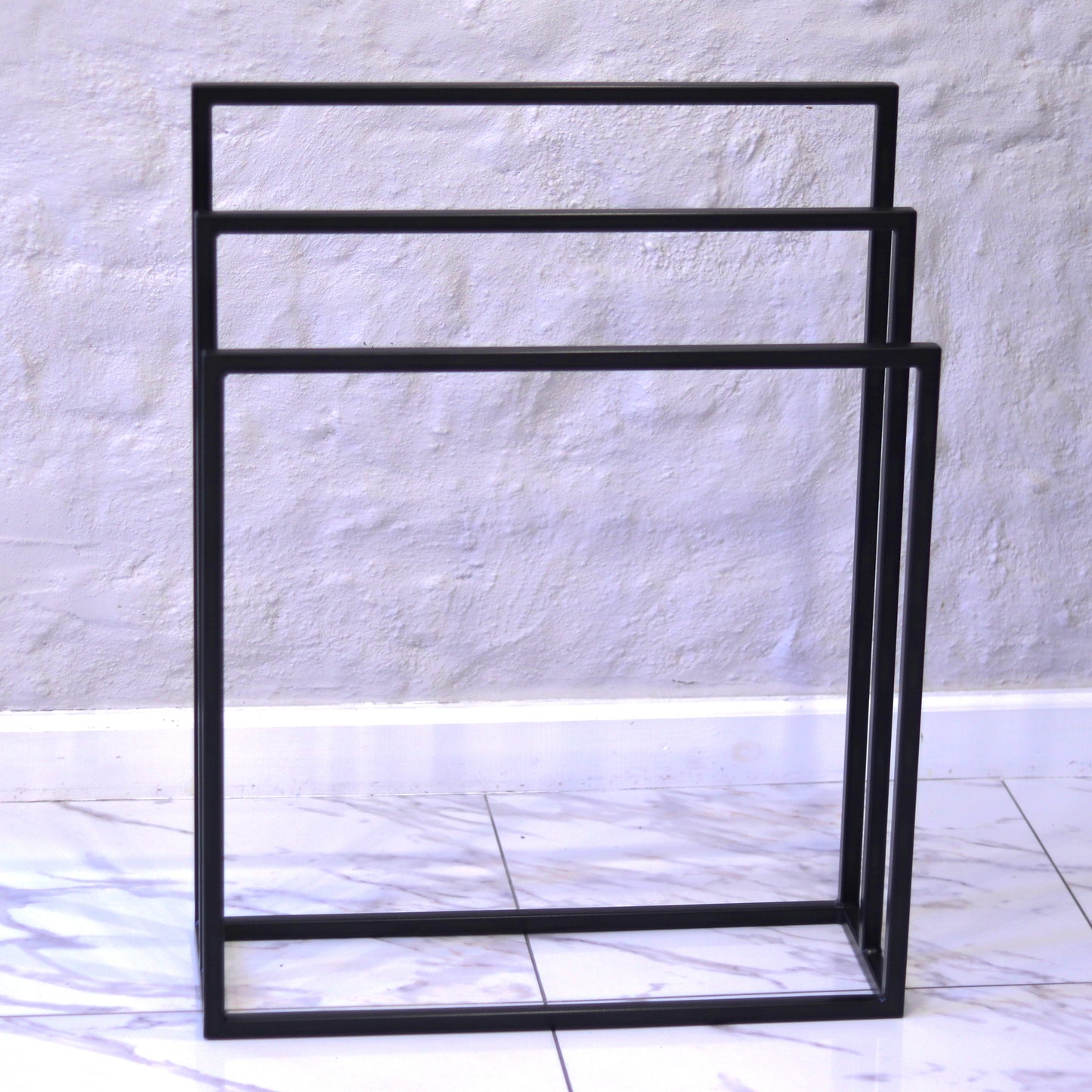 Steel towel rack shown in a modern bathroom