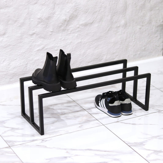 Metal shoe rack holding several pairs of shoes