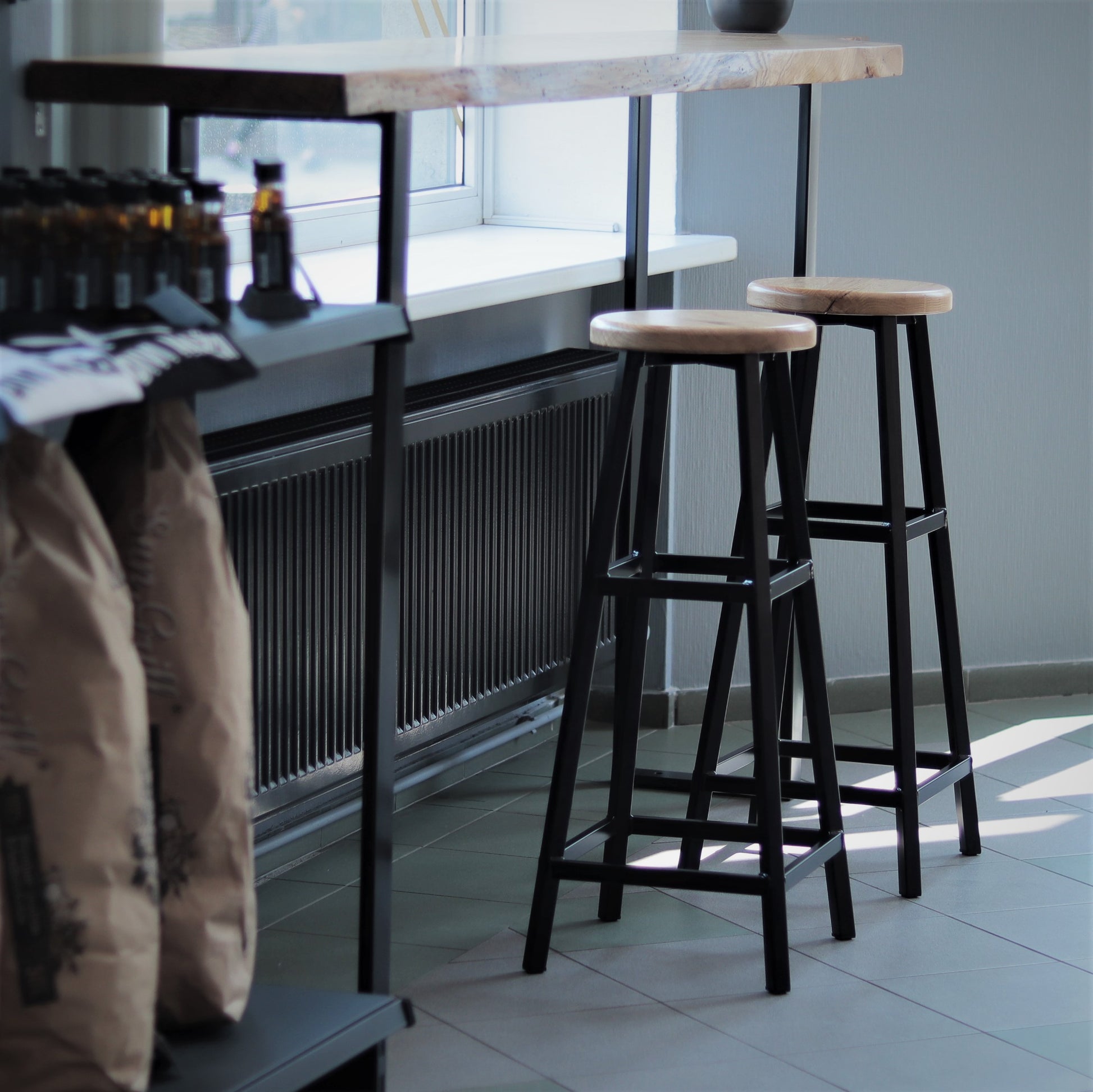 Modern bar stool with a round wooden top, side view