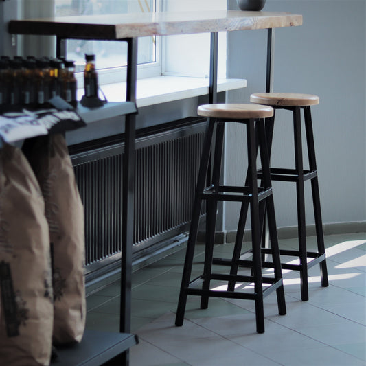 Modern bar stool with a round wooden top, side view