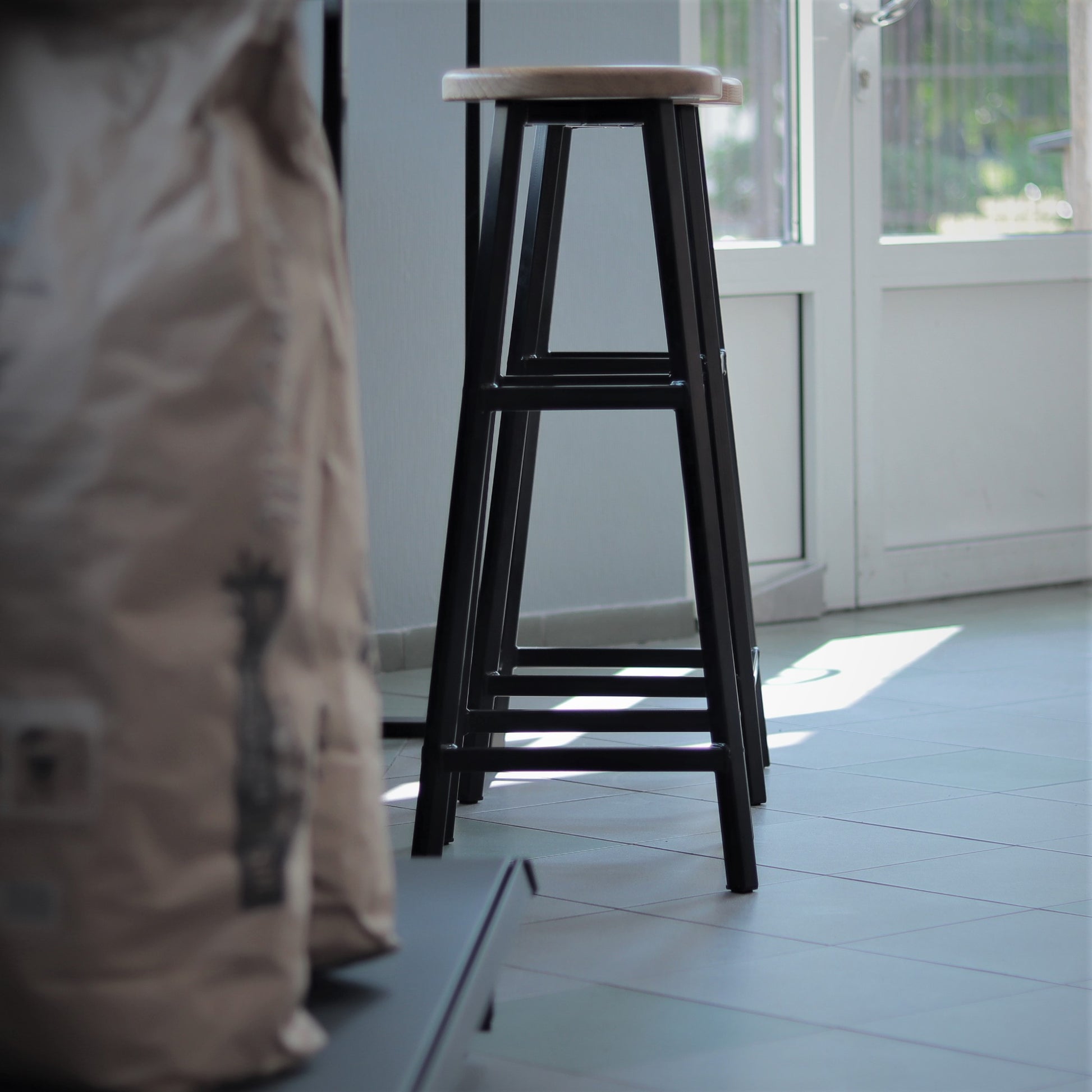 Black steel bar stool for a kitchen or home bar