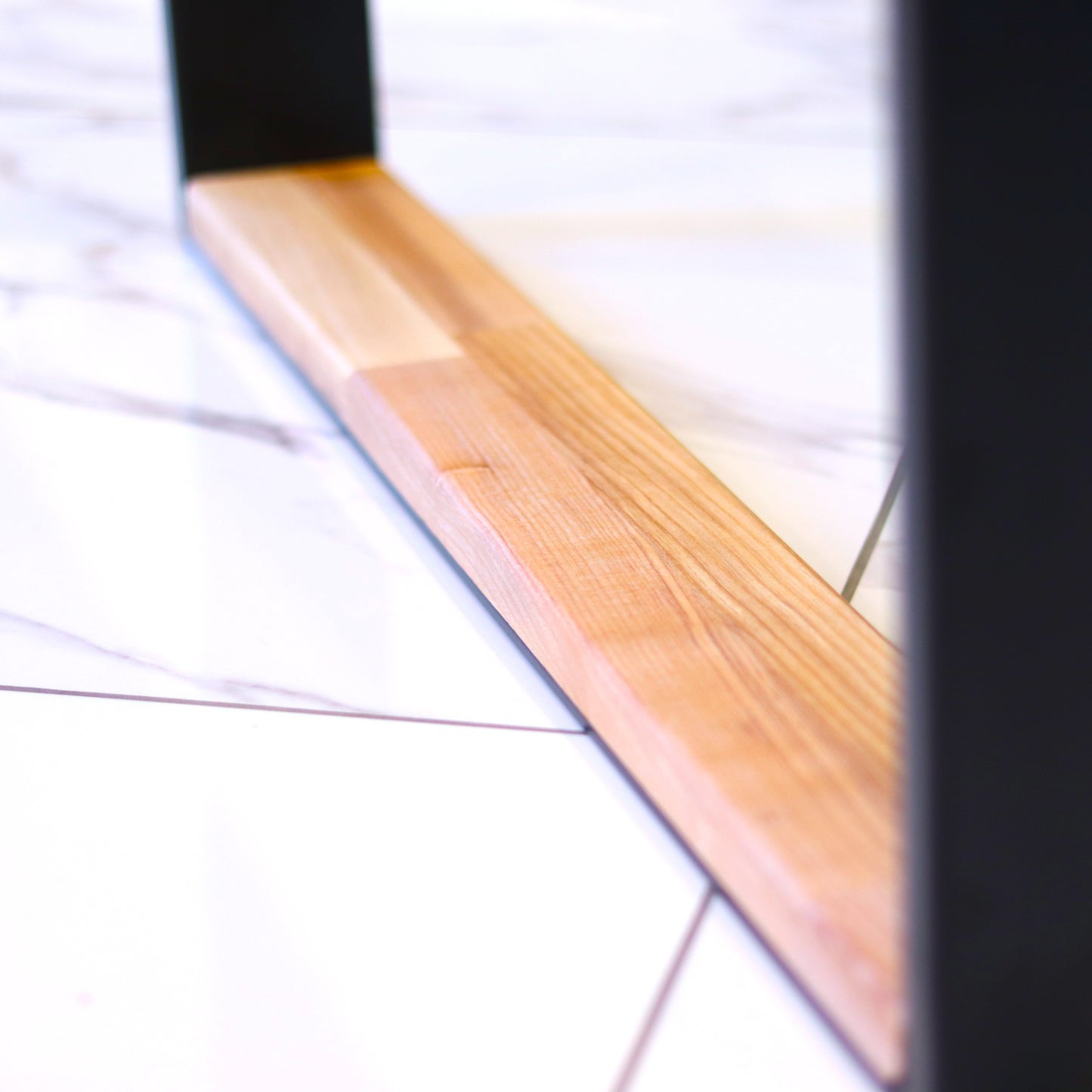 Steel and hardwood table legs, close-up