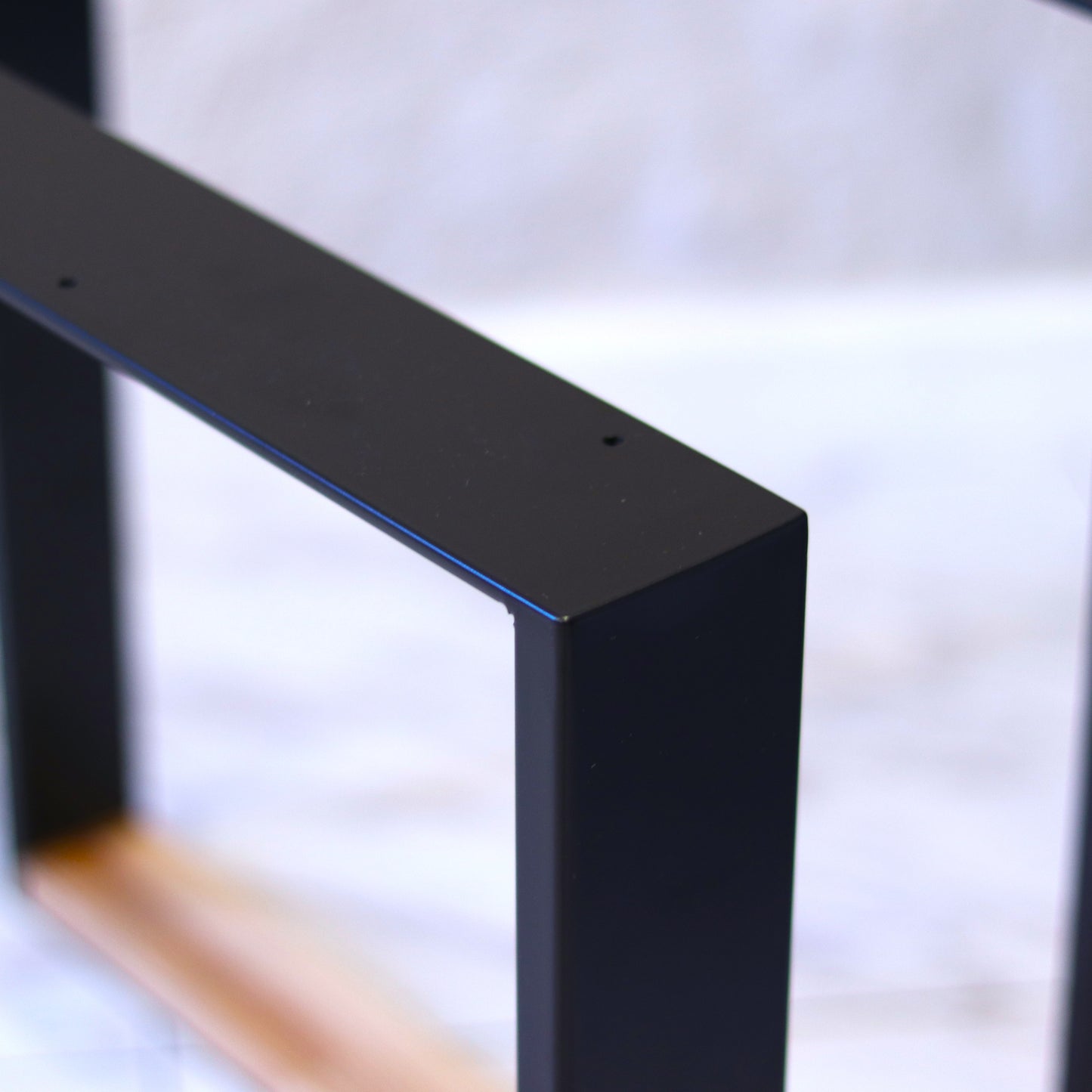 Minimalist metal table legs shown in an interior