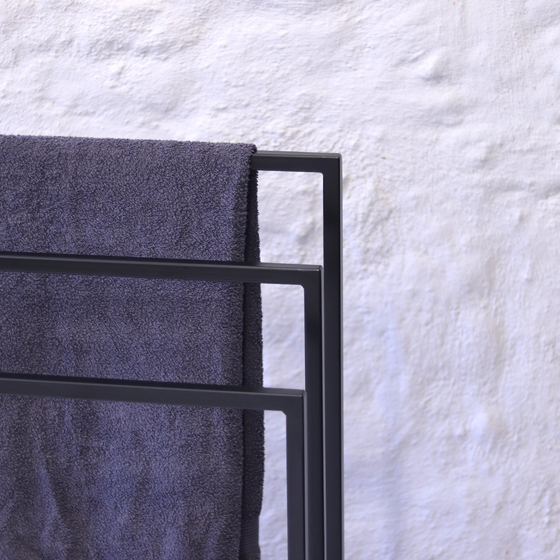 Modern powder-coated towel rack, front view