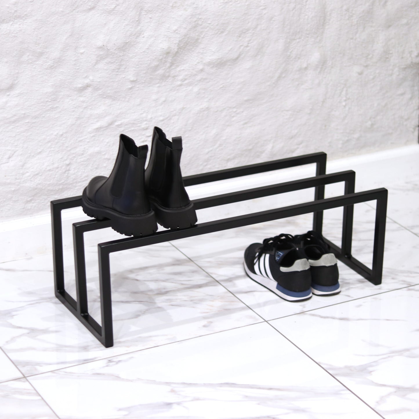 Metal shoe rack holding several pairs of shoes
