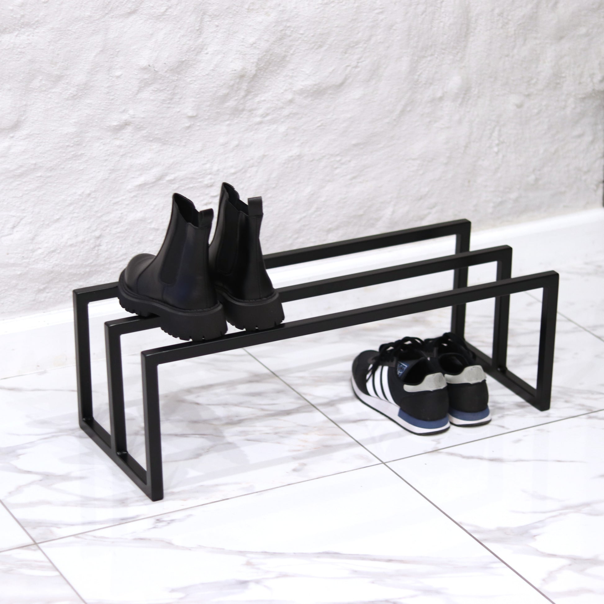Metal shoe rack holding several pairs of shoes