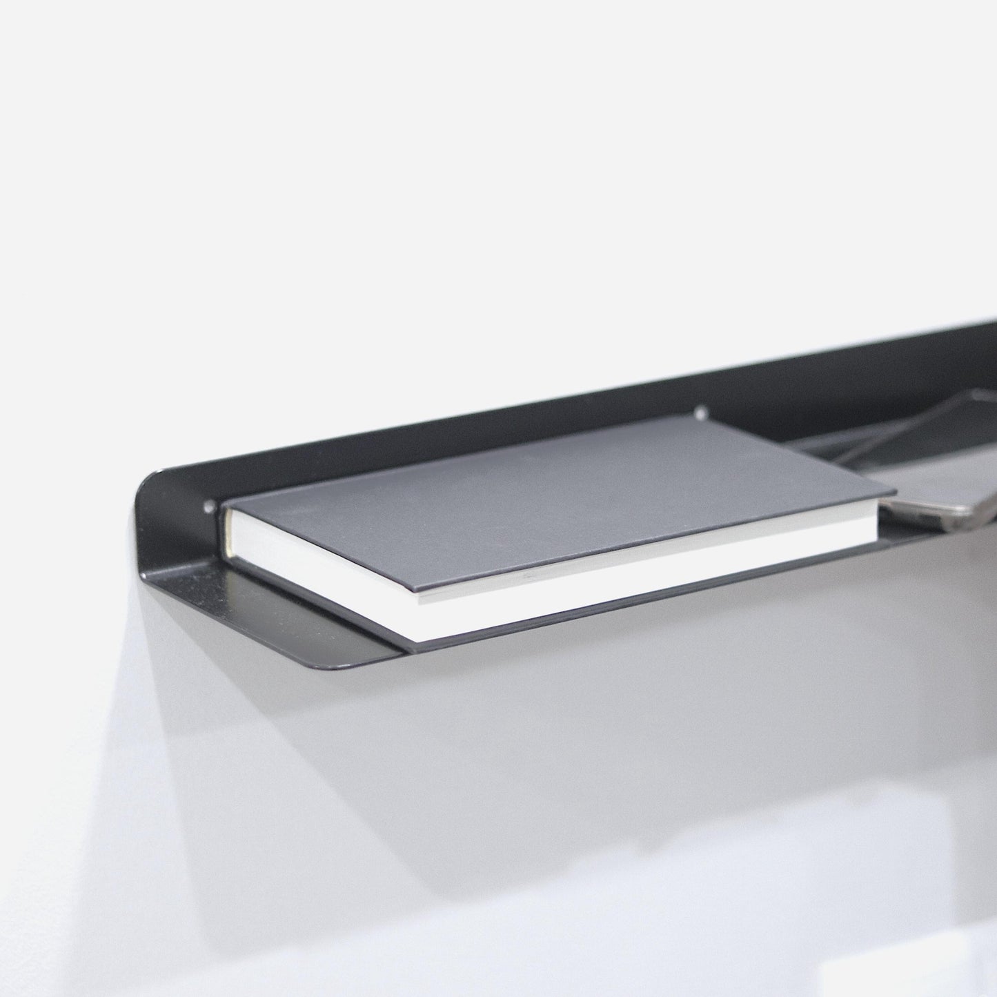 Minimalist powder-coated steel floating wall shelf