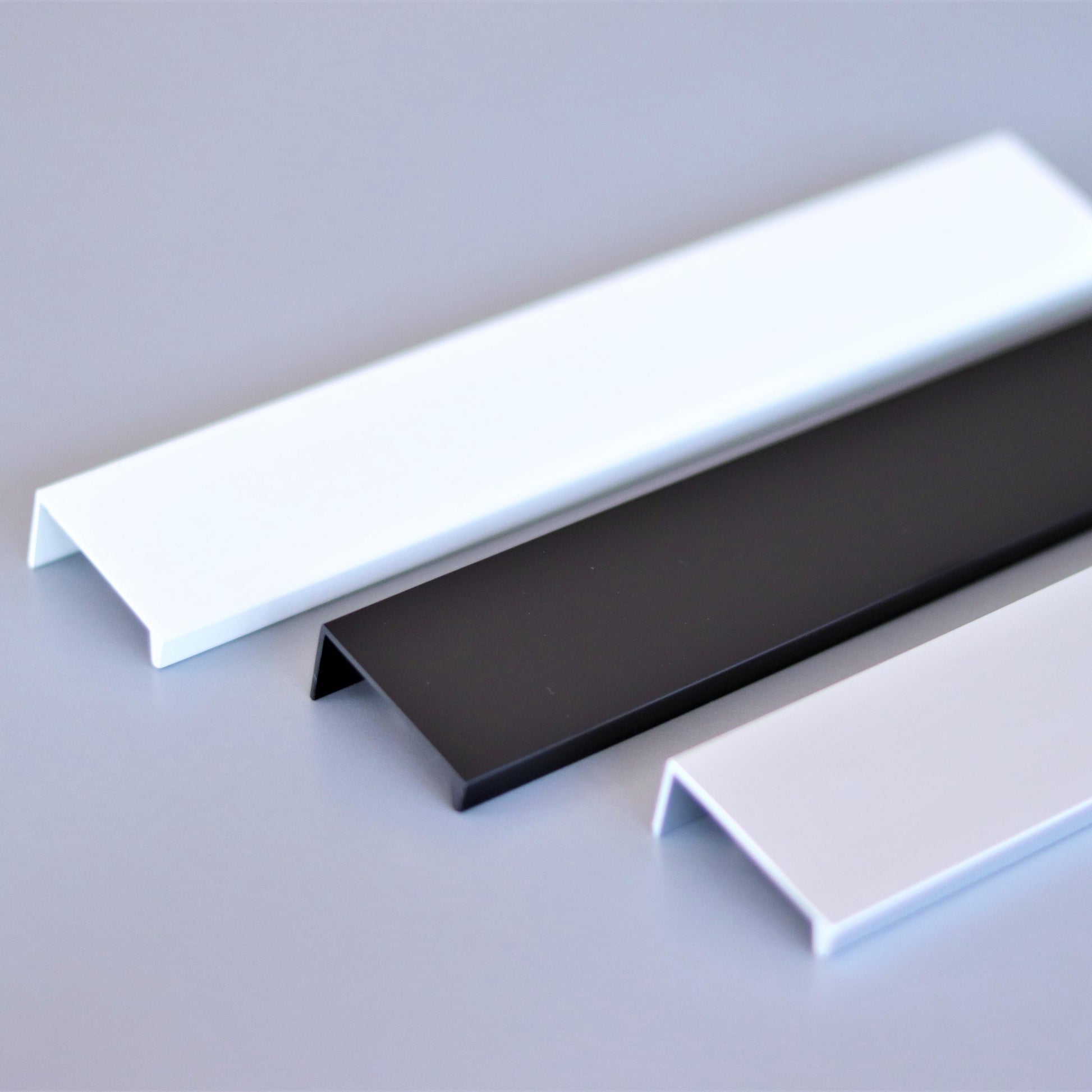 Powder-coated steel edge pull on a modern cabinet