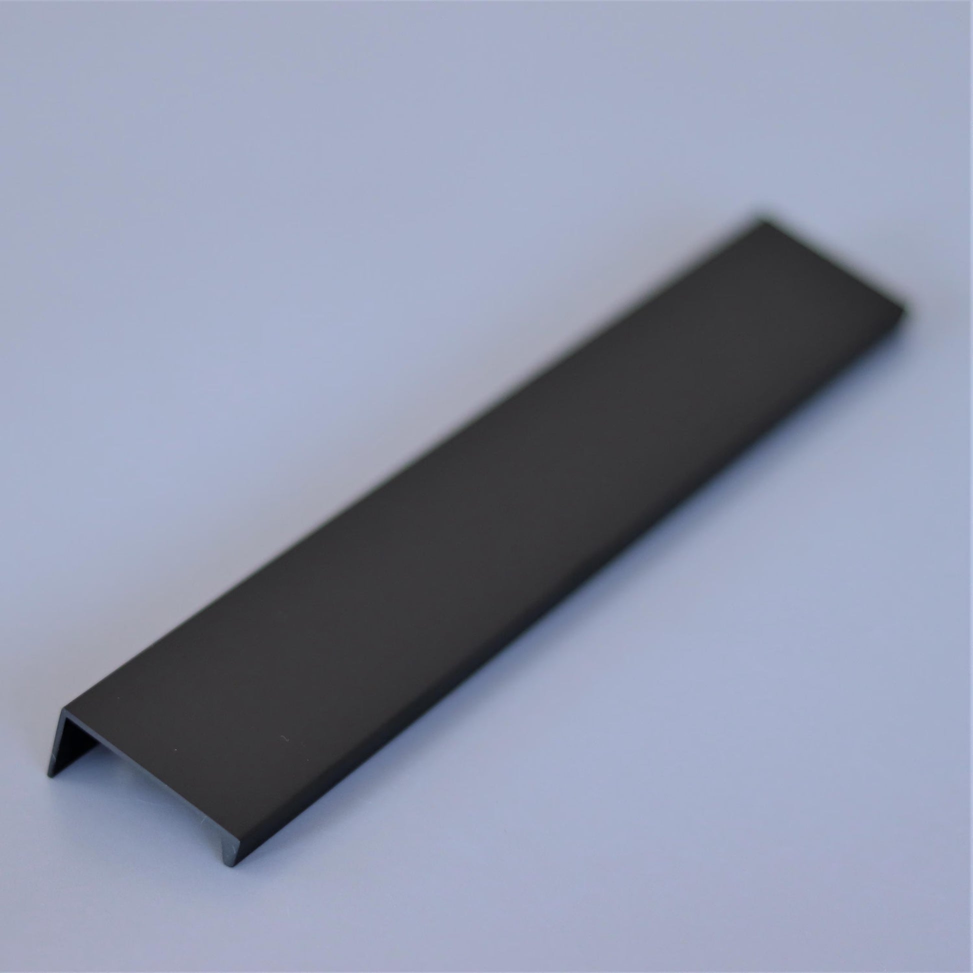 Steel edge pull handle on a cabinet door edge