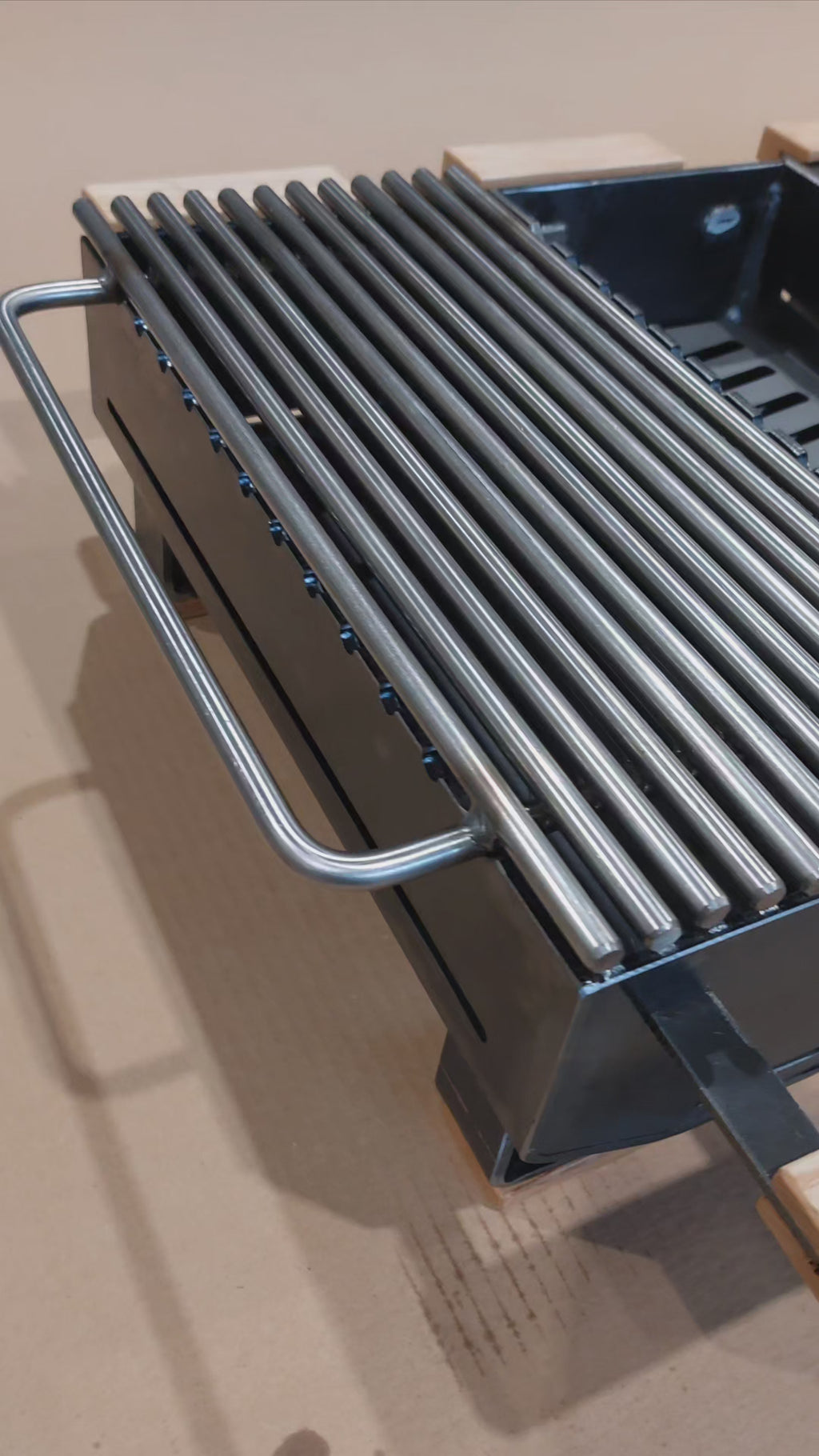 video showing 4 hibachi grills in row on brown background