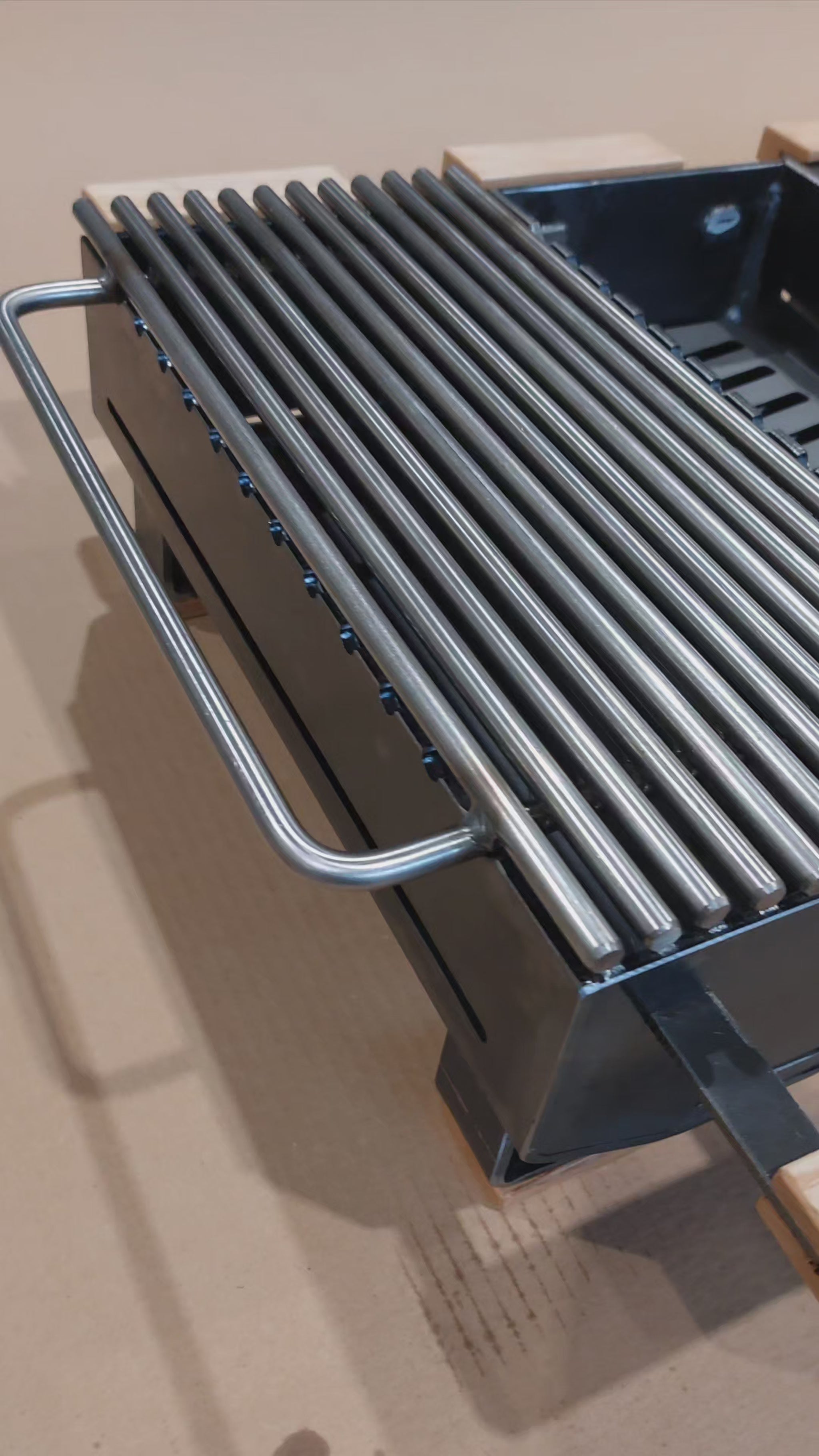 video showing 4 hibachi grills in row on brown background